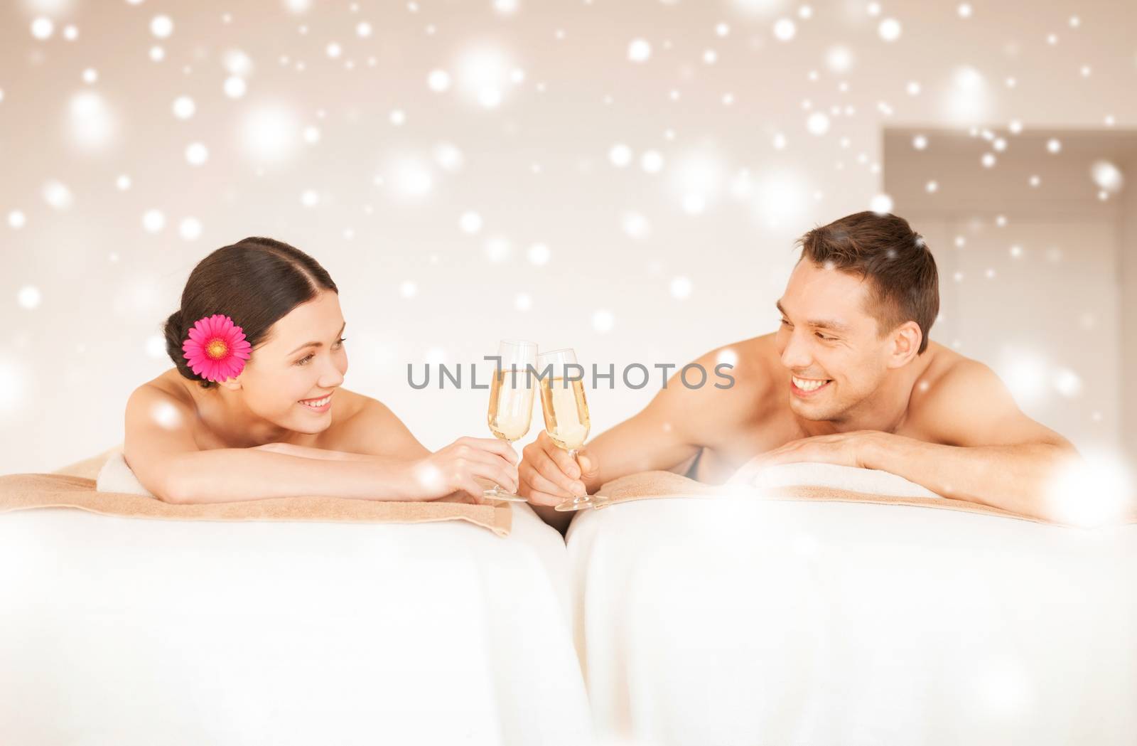 health and beauty, love, romance concept - couple in spa salon drinking champagne