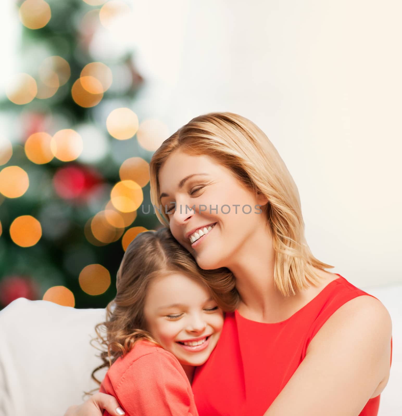 christmas, x-mas, winter, happiness concept - hugging mother and daughter