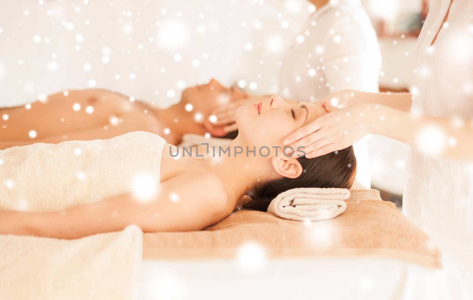 health and beauty concept - couple in spa salon getting face treatment