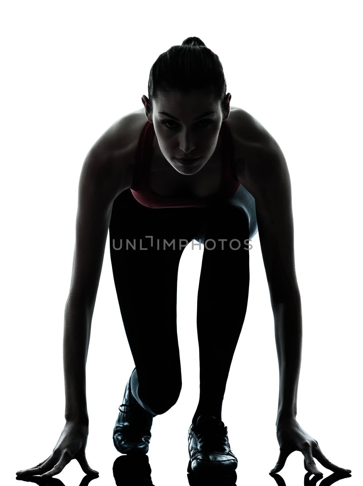 one  woman sprinter on starting block in silhouette studio isolated on white background