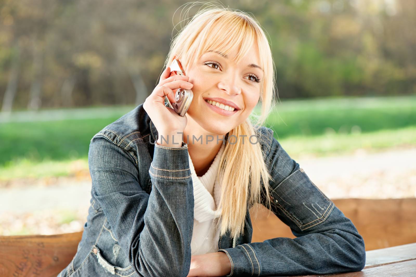 woman at park taking a phone call by imarin