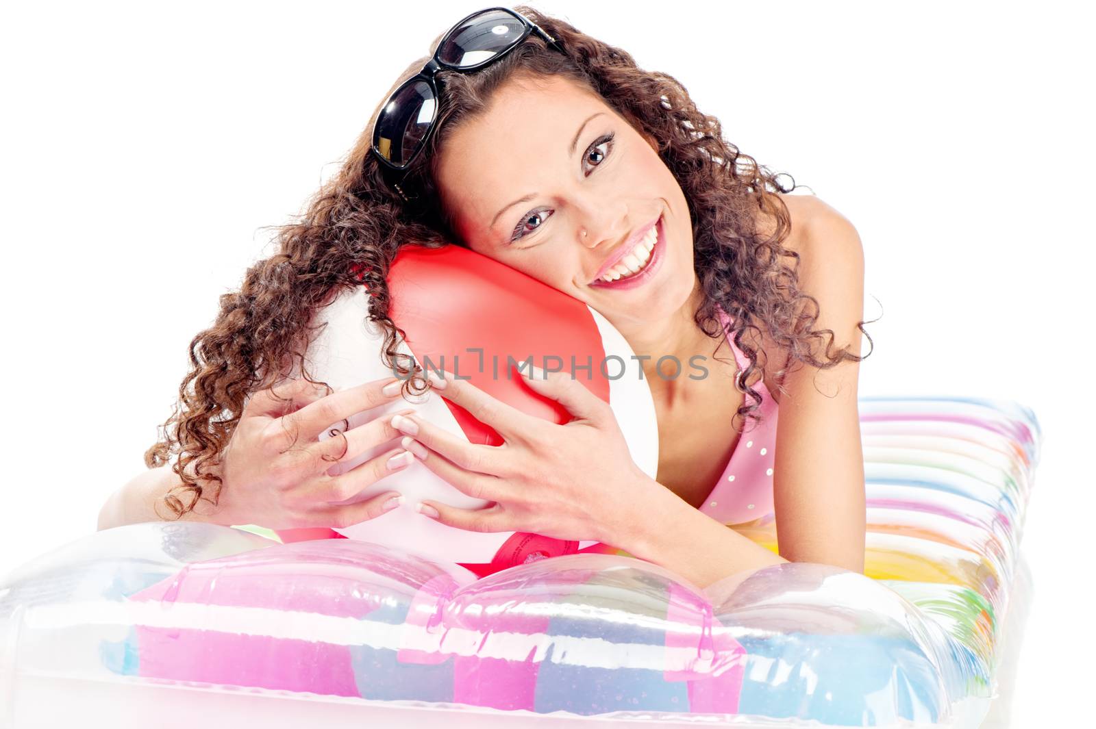 Smiled curl girl with sun glasses in hair, laying air mattress and holding the ball, isolated on white