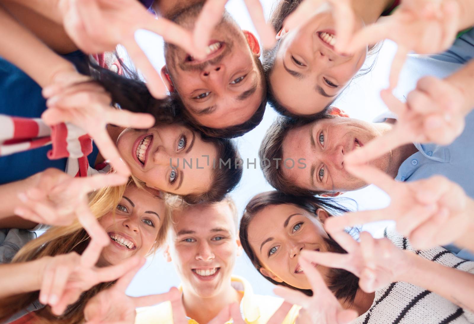 summer, holidays, vacation, happy people concept - group of teenagers looking down and showing finger five gesture