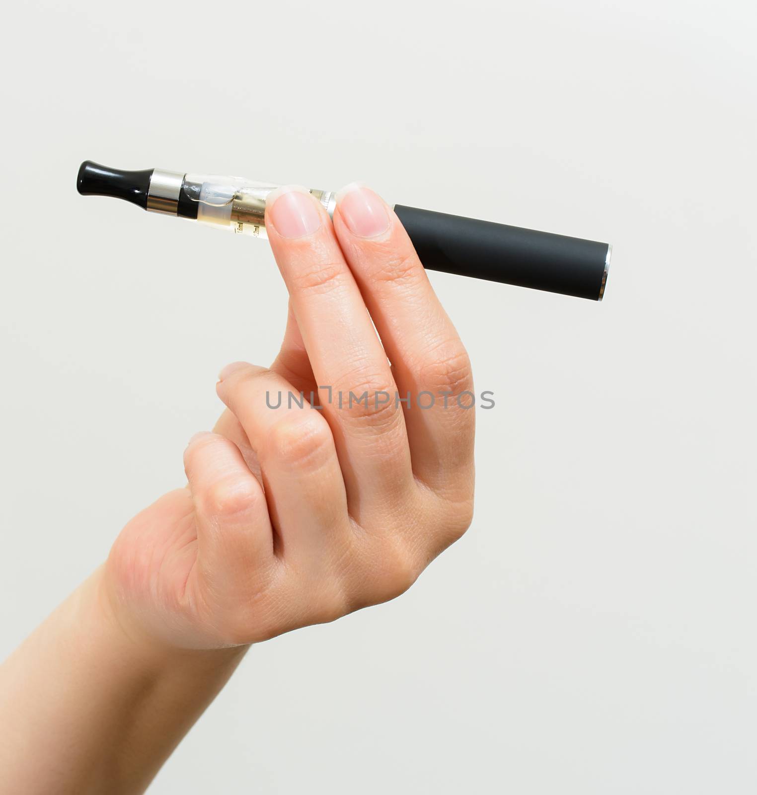 Close up of a woman hand holding an electronic cigarette 