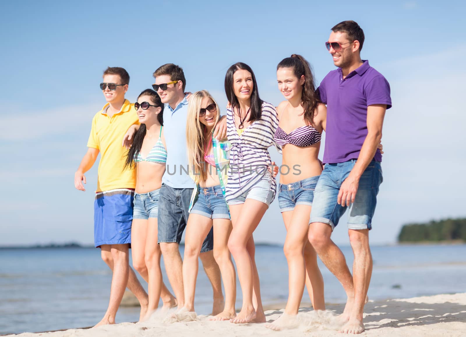 summer, holidays, vacation, happy people concept - group of friends having fun on the beach