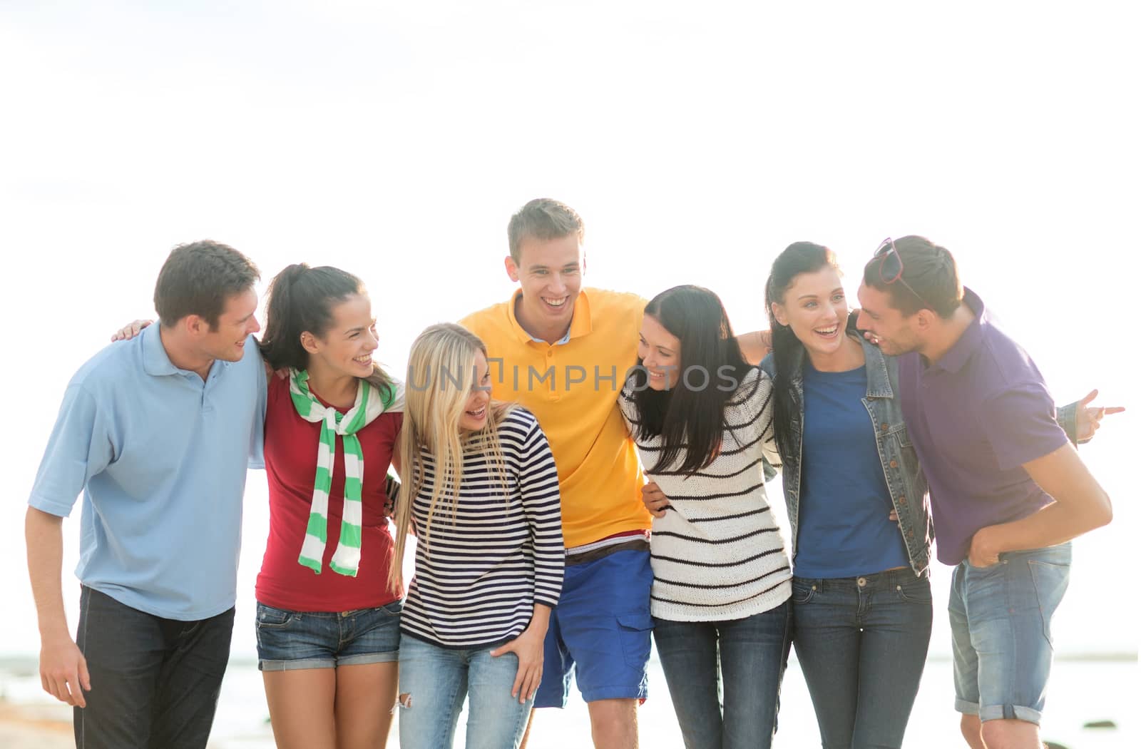 summer, holidays, vacation, happy people concept - group of friends having fun on the beach