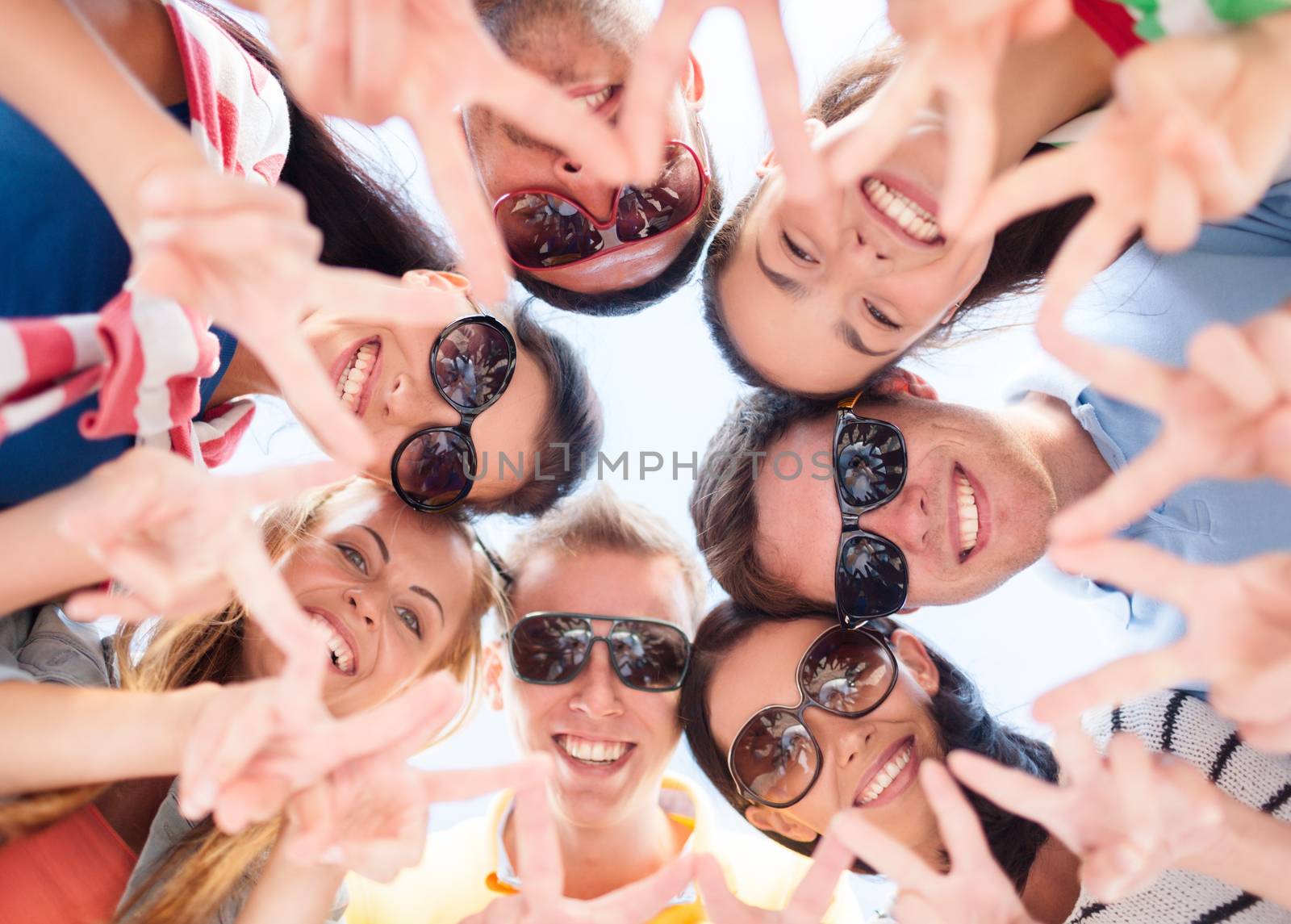 group of teenagers showing finger five gesture by dolgachov