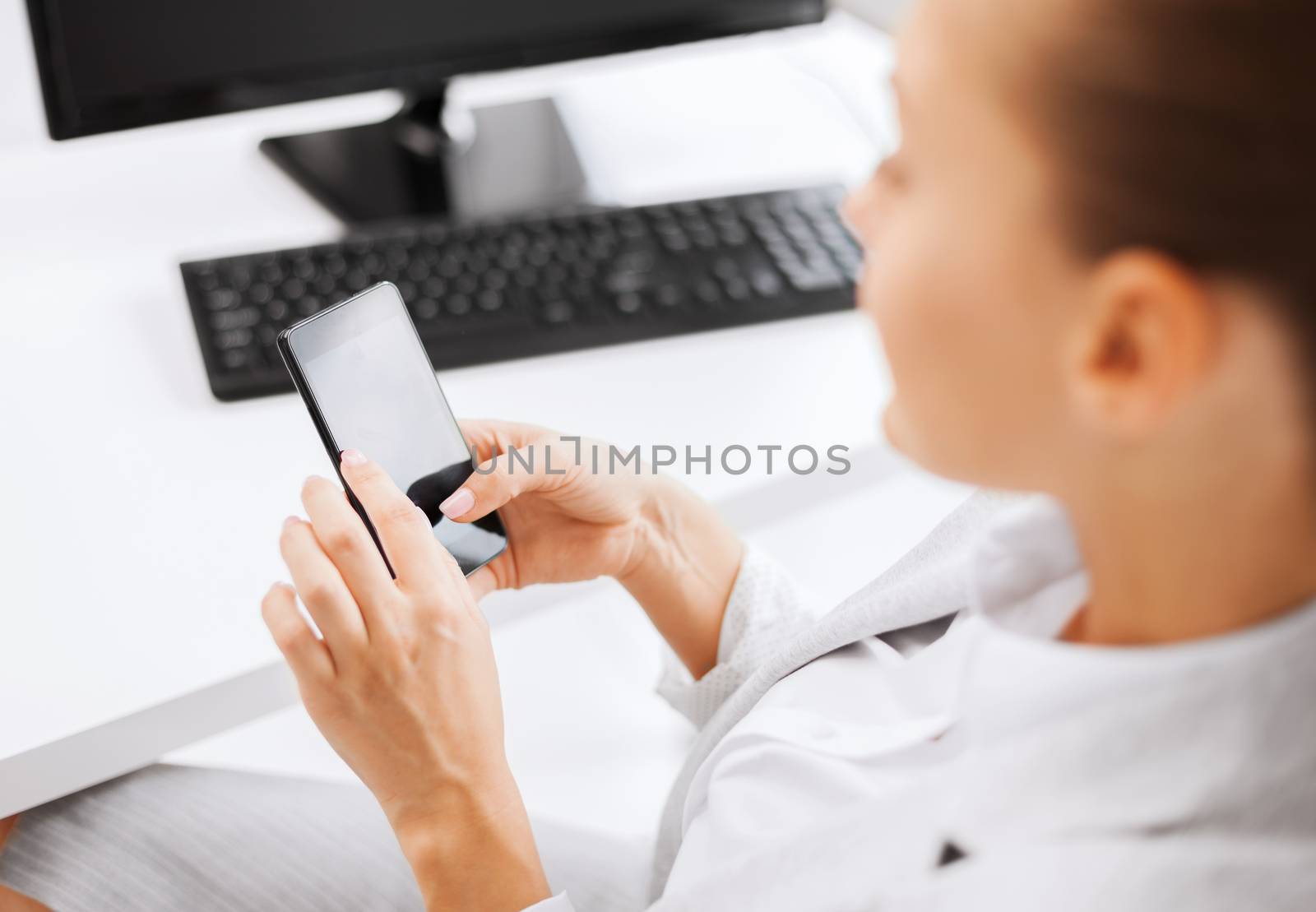business, office, school and education concept - businesswoman with smartphone in office
