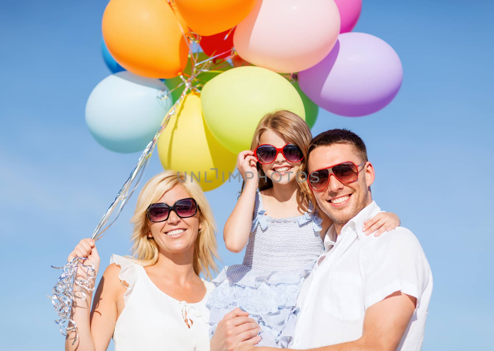 summer holidays, celebration, children and people concept - family with colorful balloons