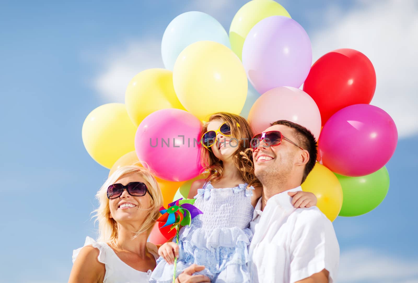 family with colorful balloons by dolgachov