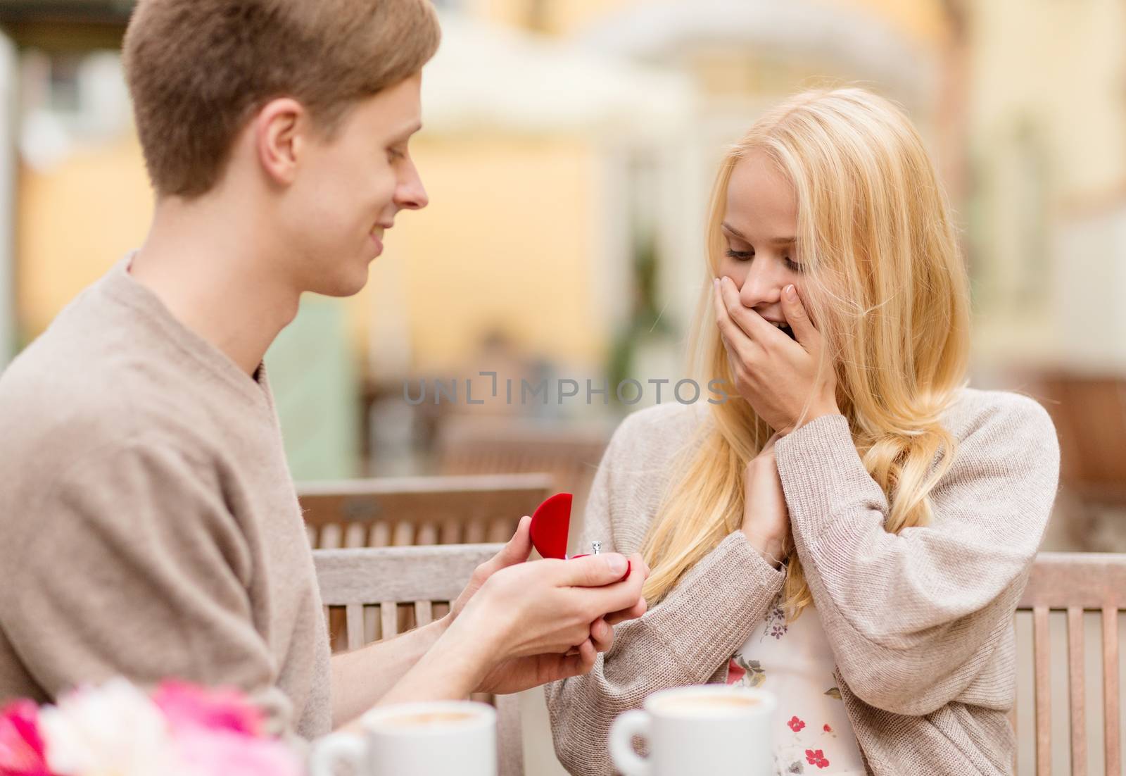 romantic man proposing to beautiful woman by dolgachov