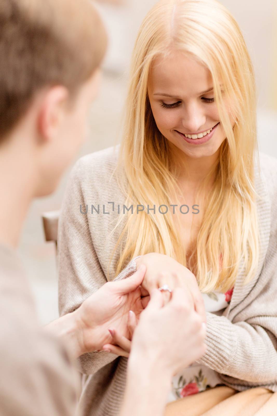 summer holidays, love, travel, tourism, relationship and dating concept - romantic man proposing to beautiful woman