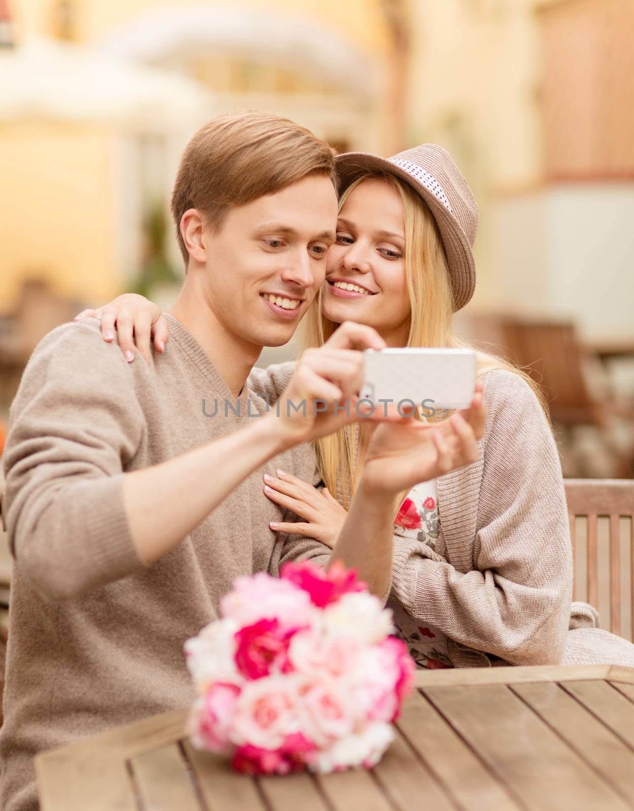 summer holidays, dating and technology concept - couple taking picture with smartphone at cafe in the city