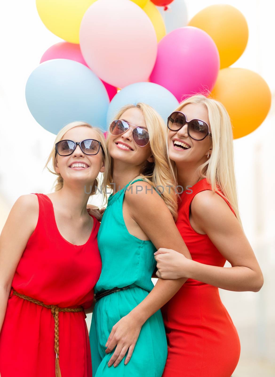 holidays and tourism, friends, hen party, blonde girls concept - three beautiful women with colorful balloons in the city