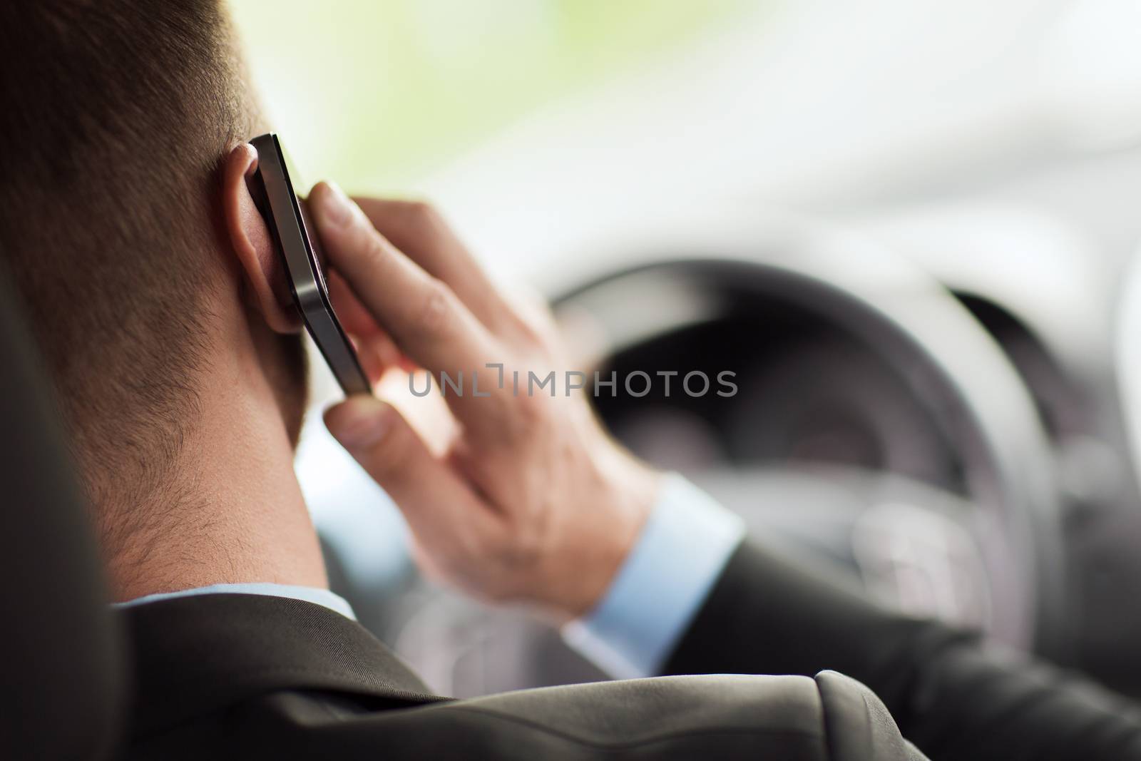 man using phone while driving the car by dolgachov