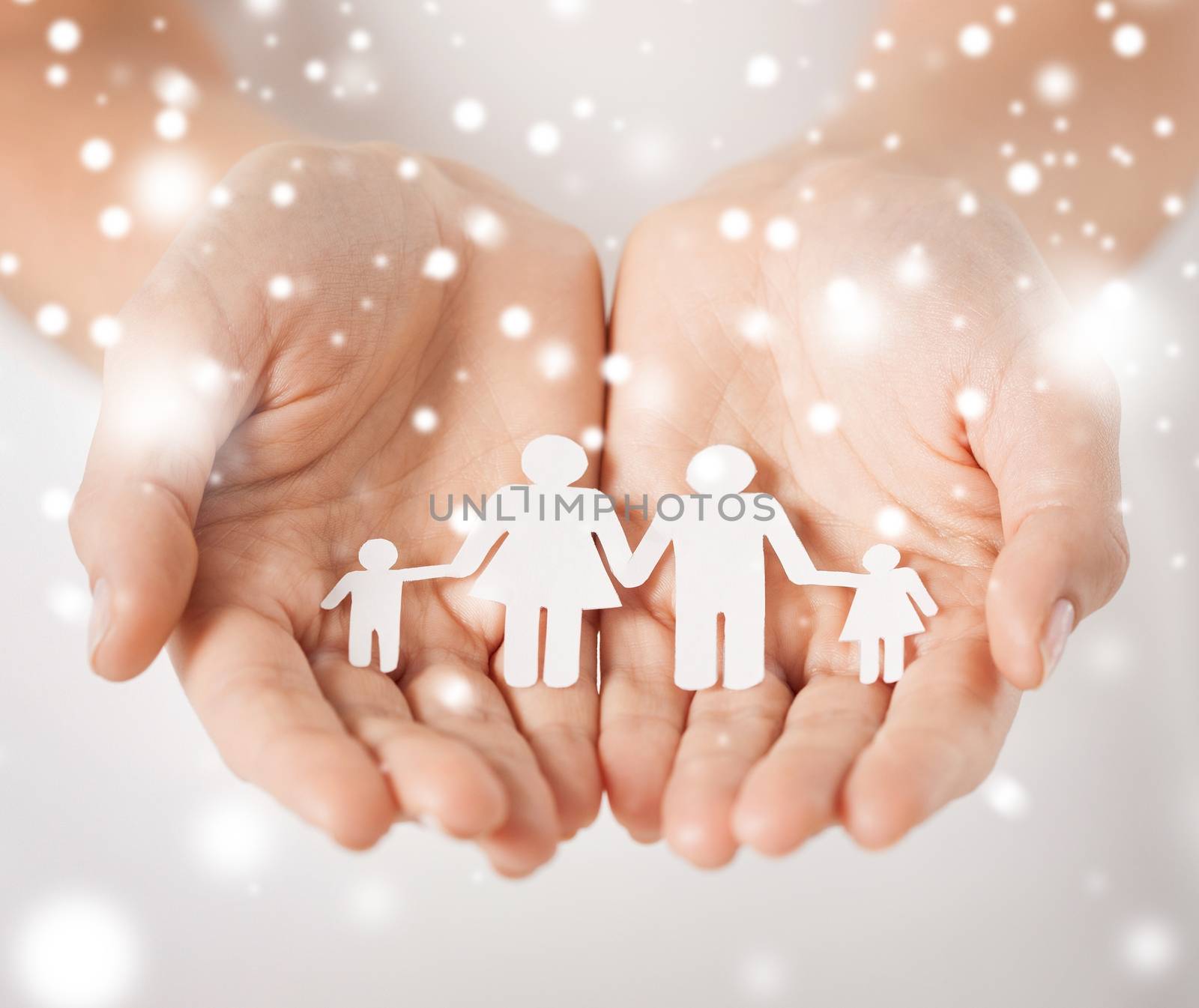 family, children, christmas, x-mas and happy people concept - woman cupped hands showing paper man family