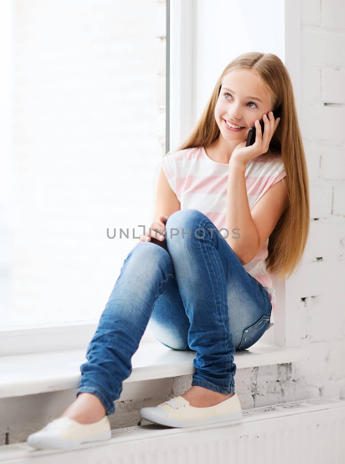 girl with smartphone at school by dolgachov