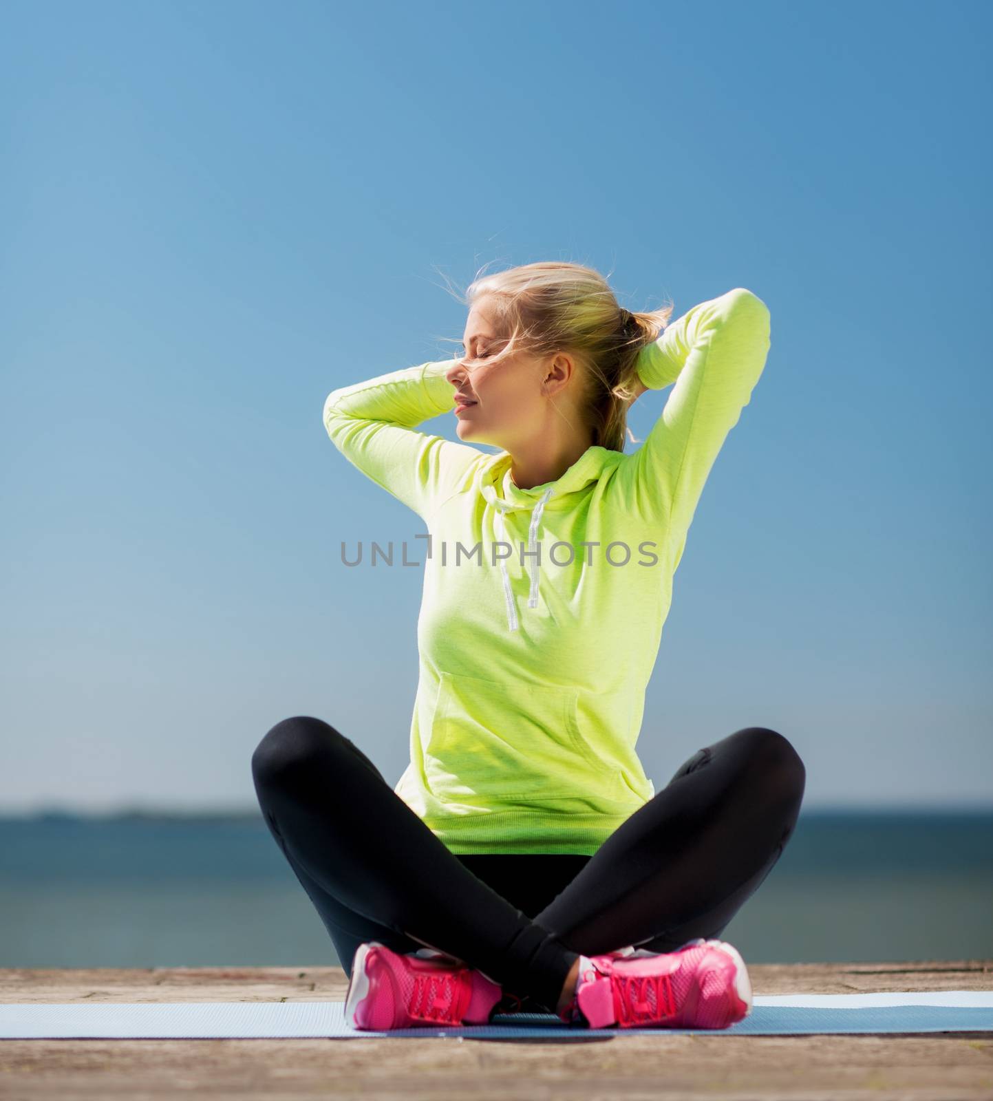 sport and lifestyle concept - woman doing yoga outdoors