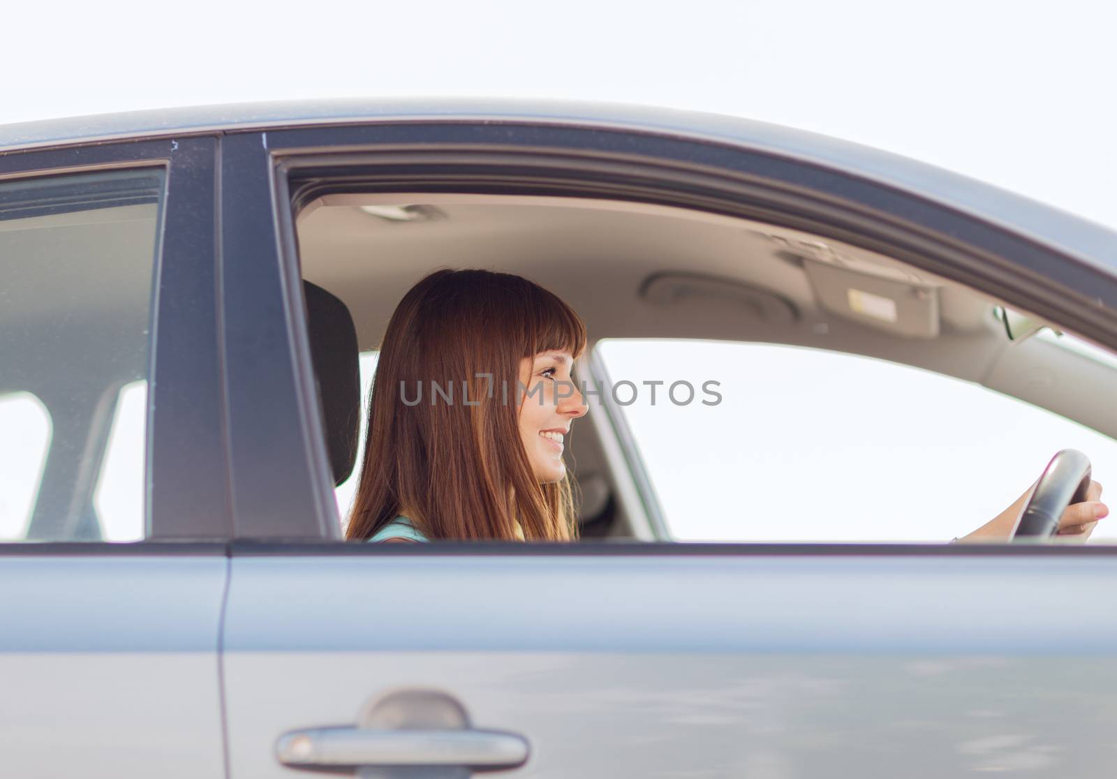 transportation and vehicle concept - happy woman driving a car