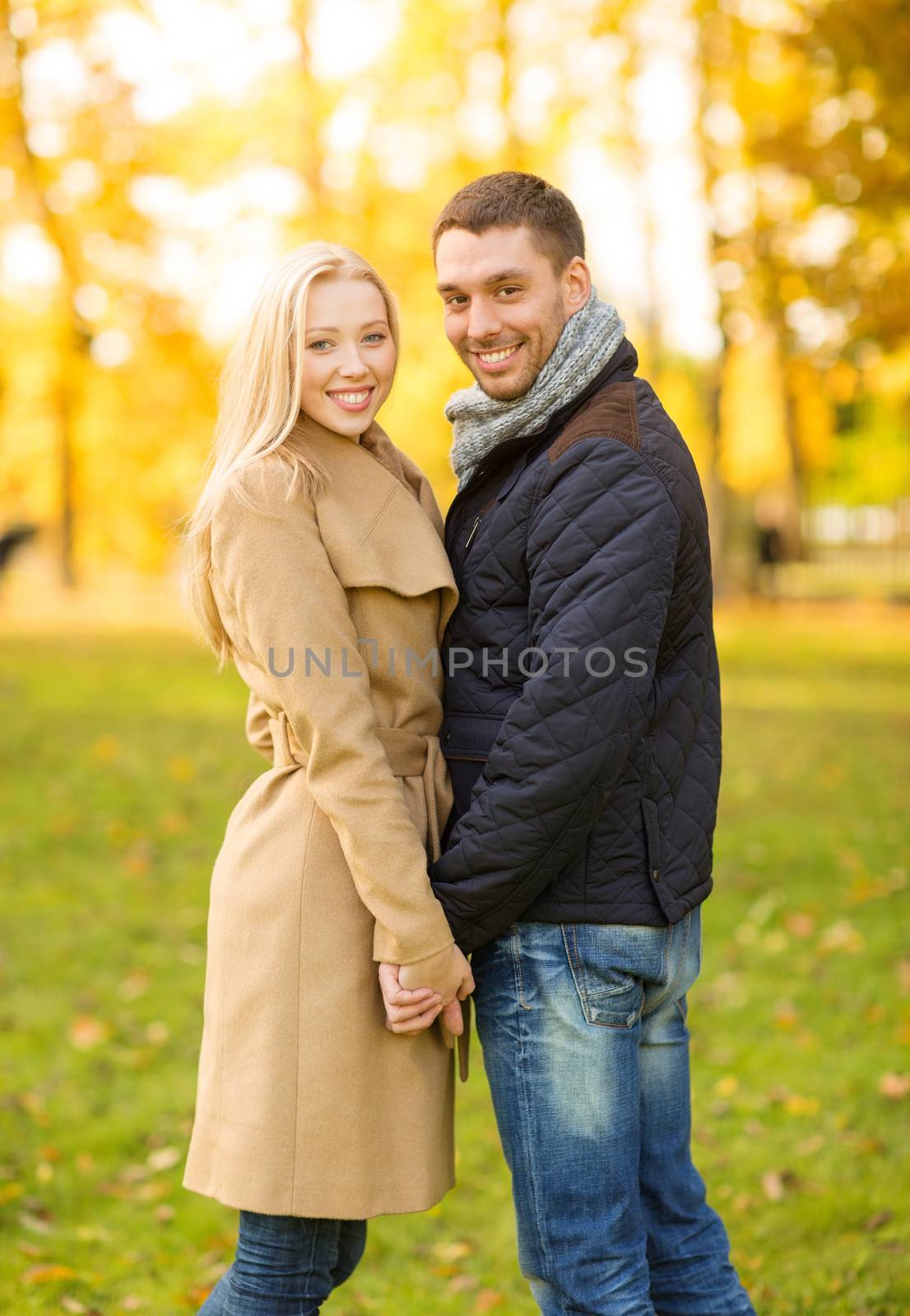 holidays, love, travel, tourism, relationship and dating concept - romantic couple in the autumn park