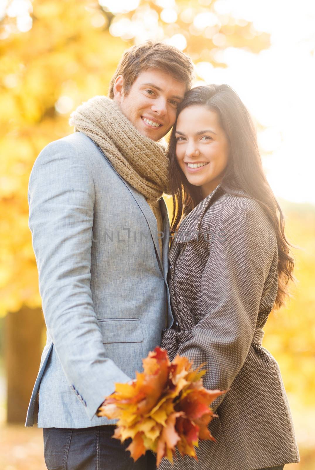 holidays, love, travel, tourism, relationship and dating concept - romantic couple in the autumn park