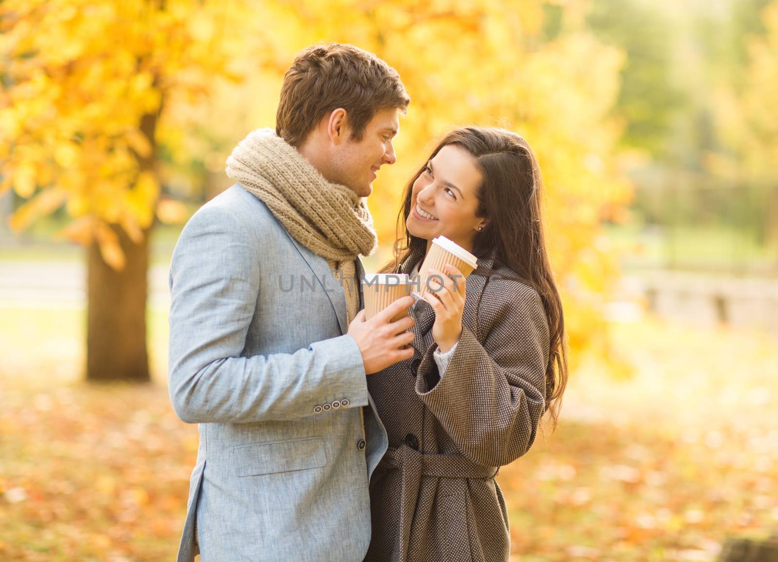 holidays, love, travel, tourism, relationship and dating concept - romantic couple in the autumn park