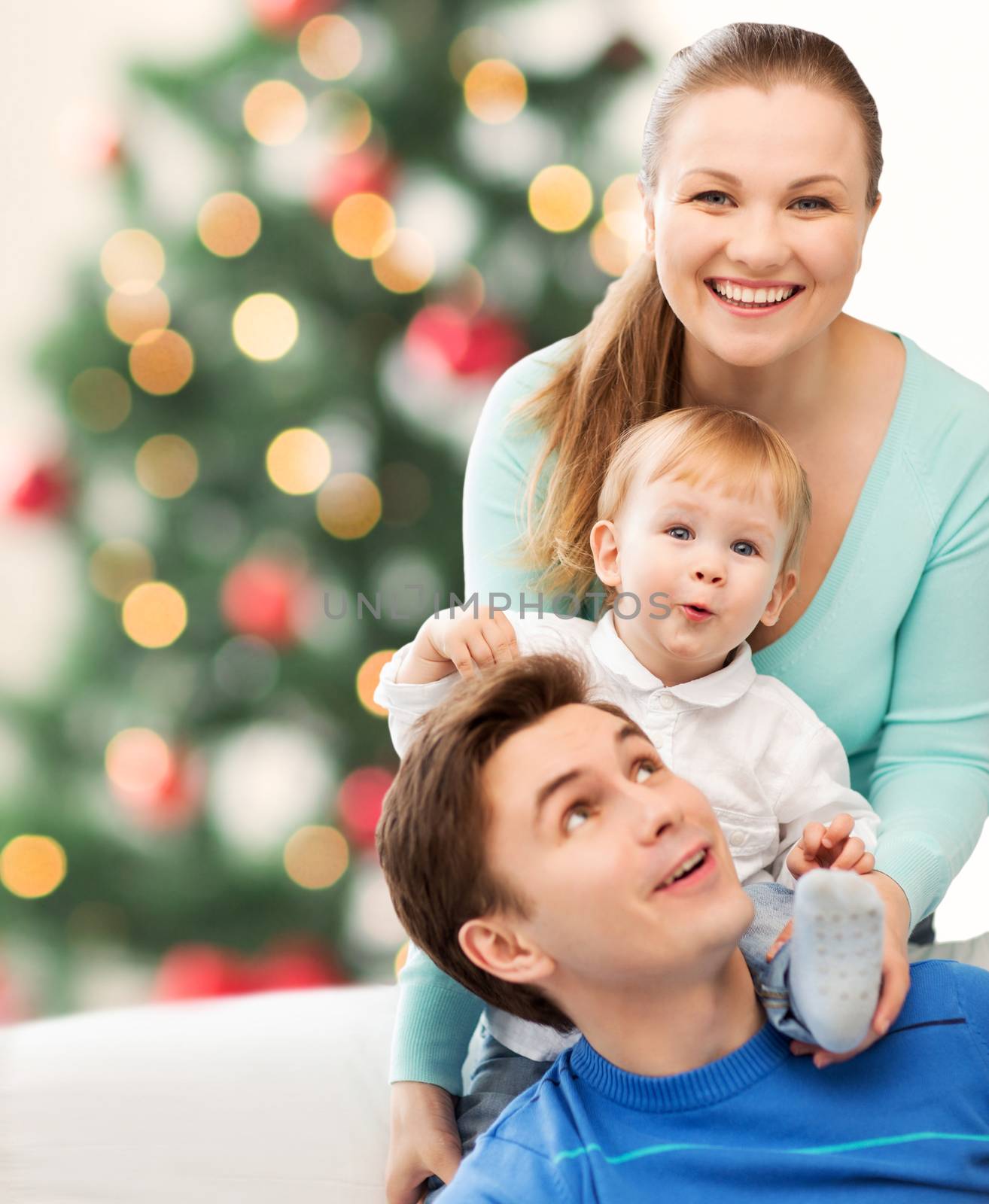 christmas, x-mas, winter, family, people, happiness concept - happy parents playing with adorable baby