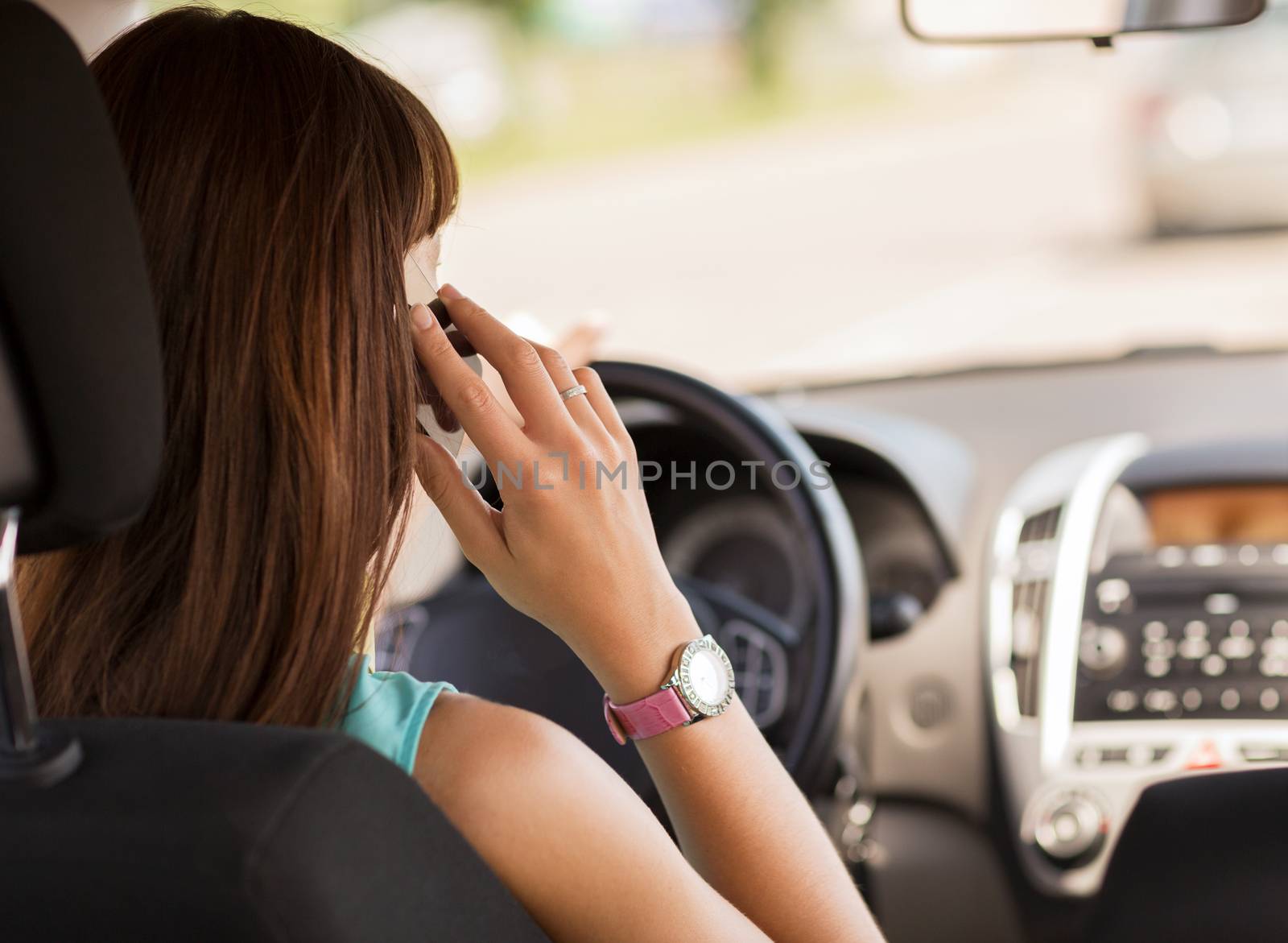 woman using phone while driving the car by dolgachov
