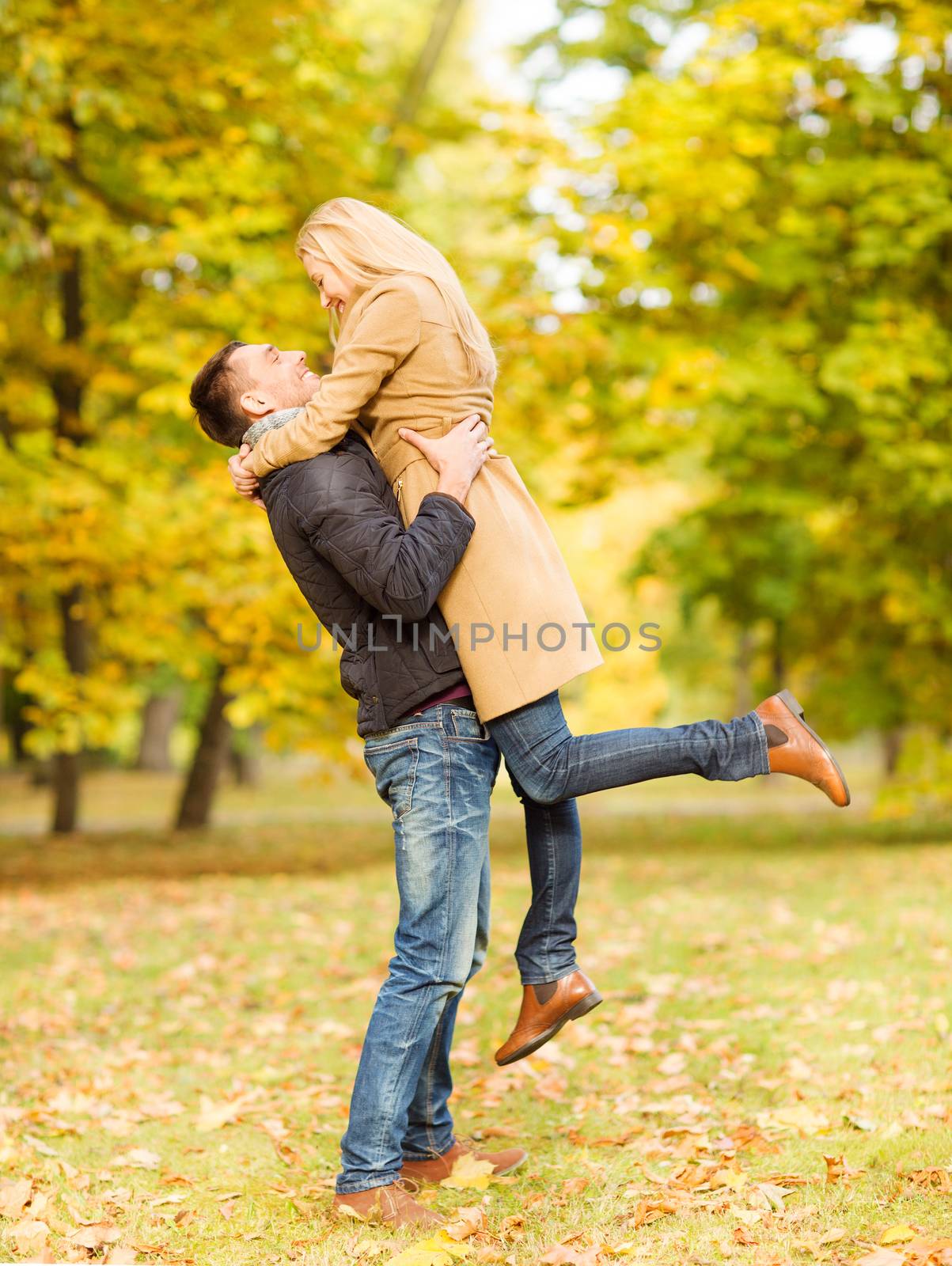romantic couple playing in the autumn park by dolgachov