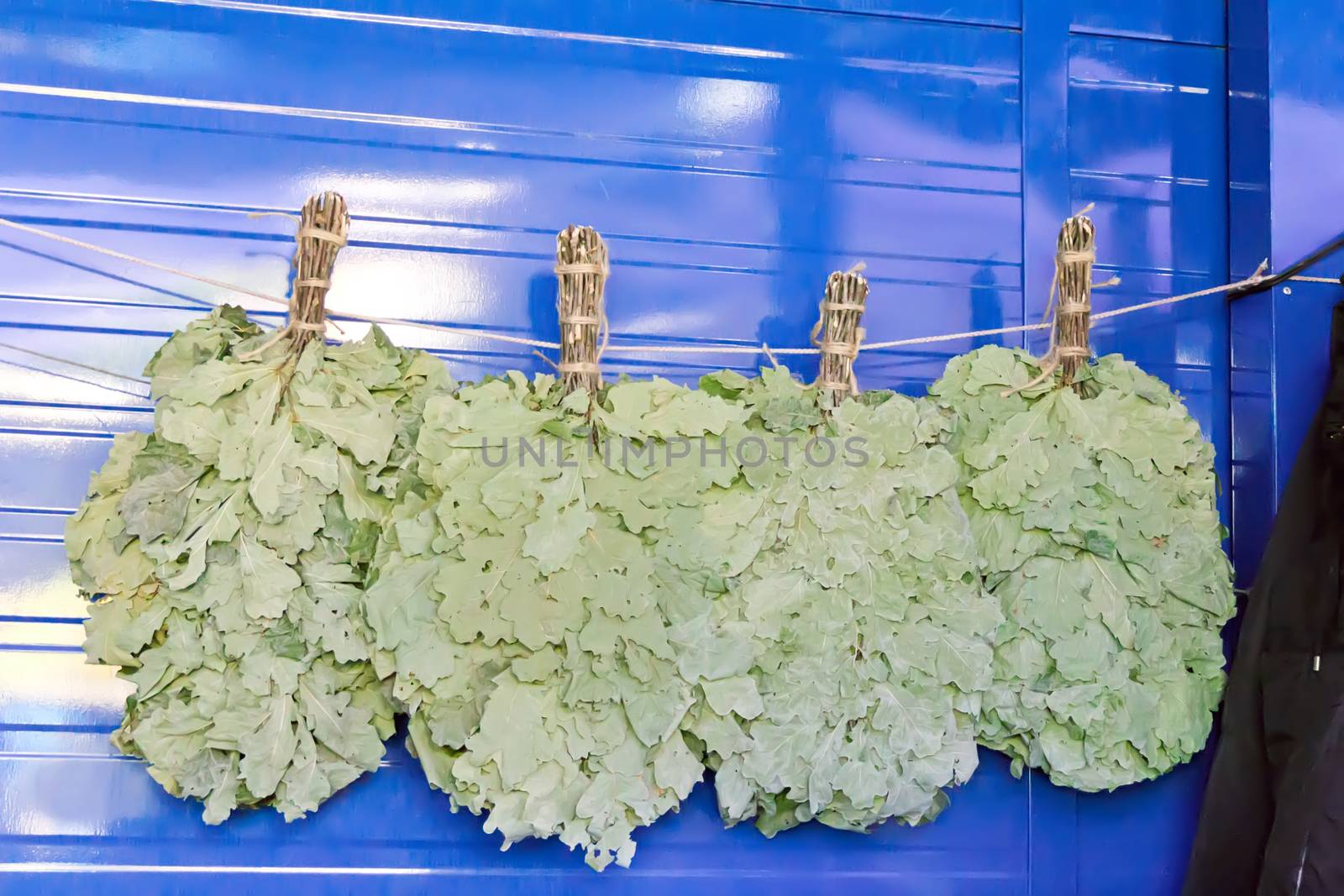 Photo of lot oak besoms in the market place