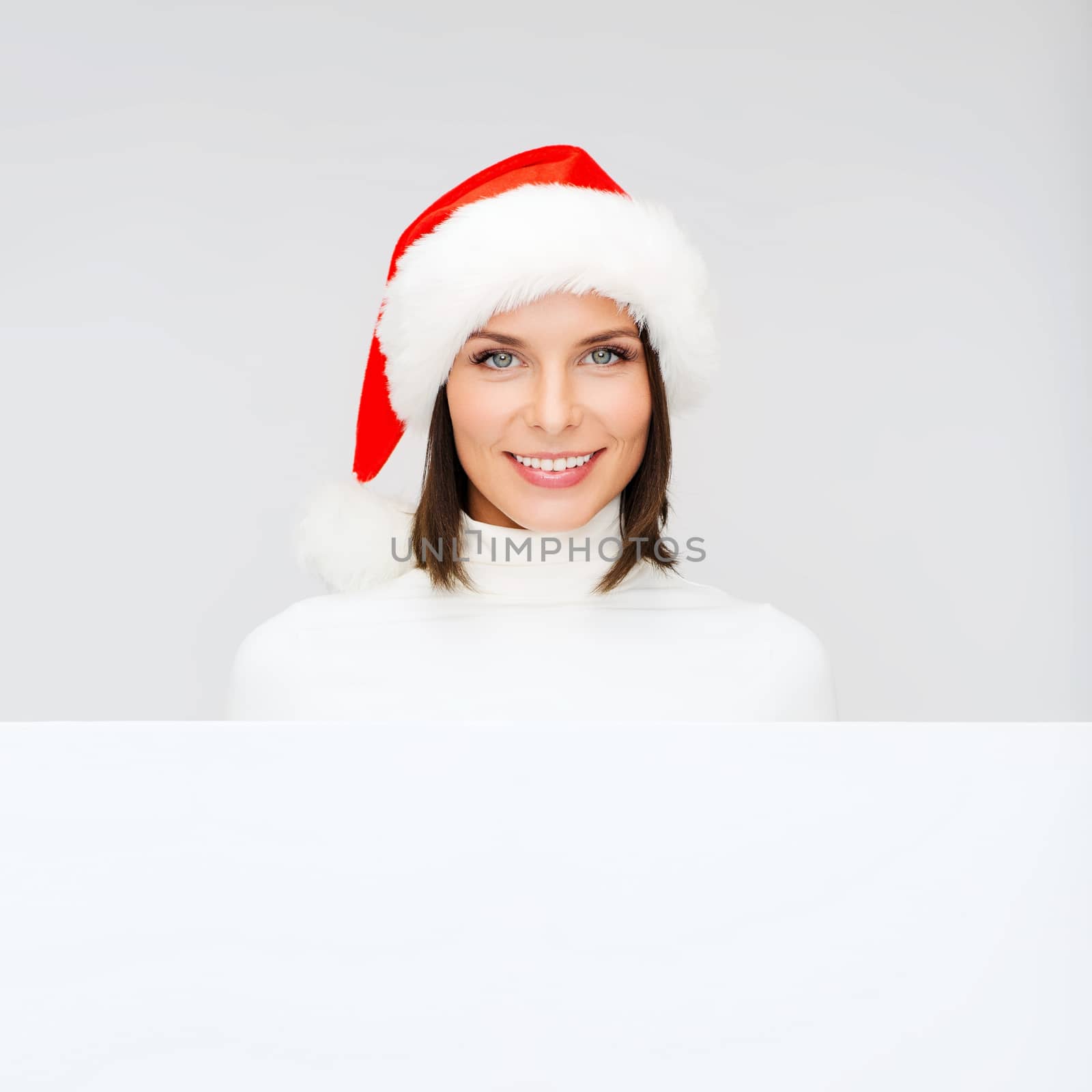 woman in santa helper hat with blank white board by dolgachov