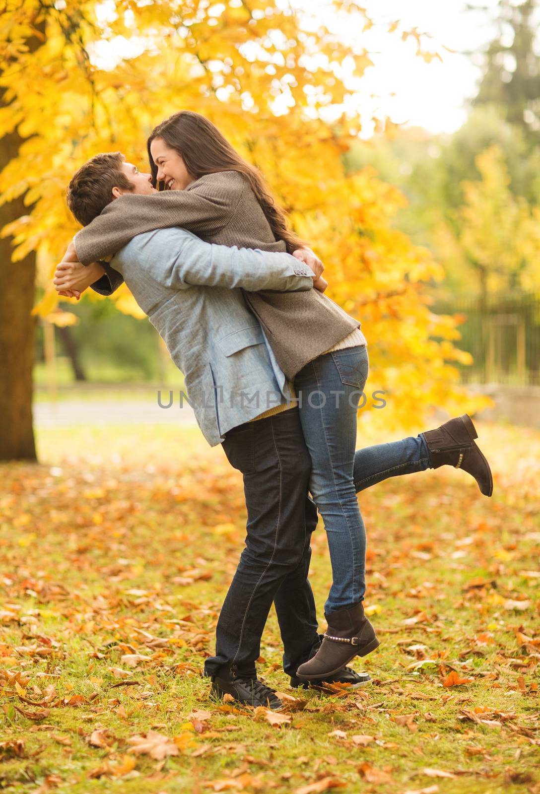 romantic couple playing in the autumn park by dolgachov