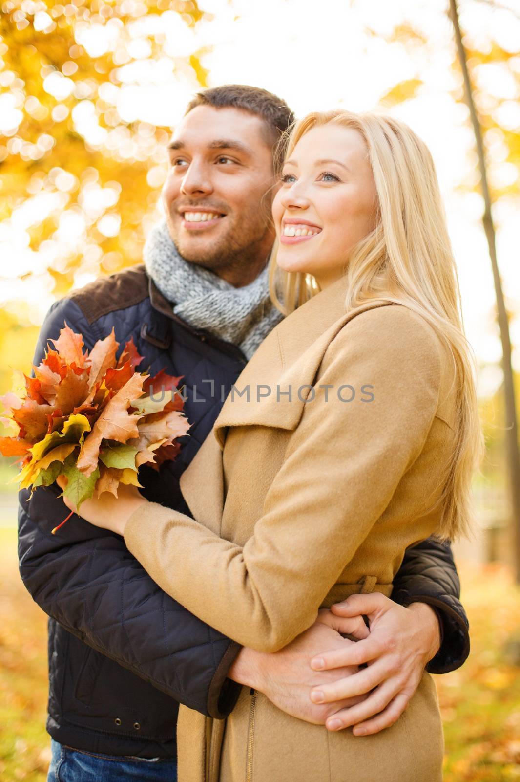 holidays, love, travel, tourism, relationship and dating concept - romantic couple in the autumn park