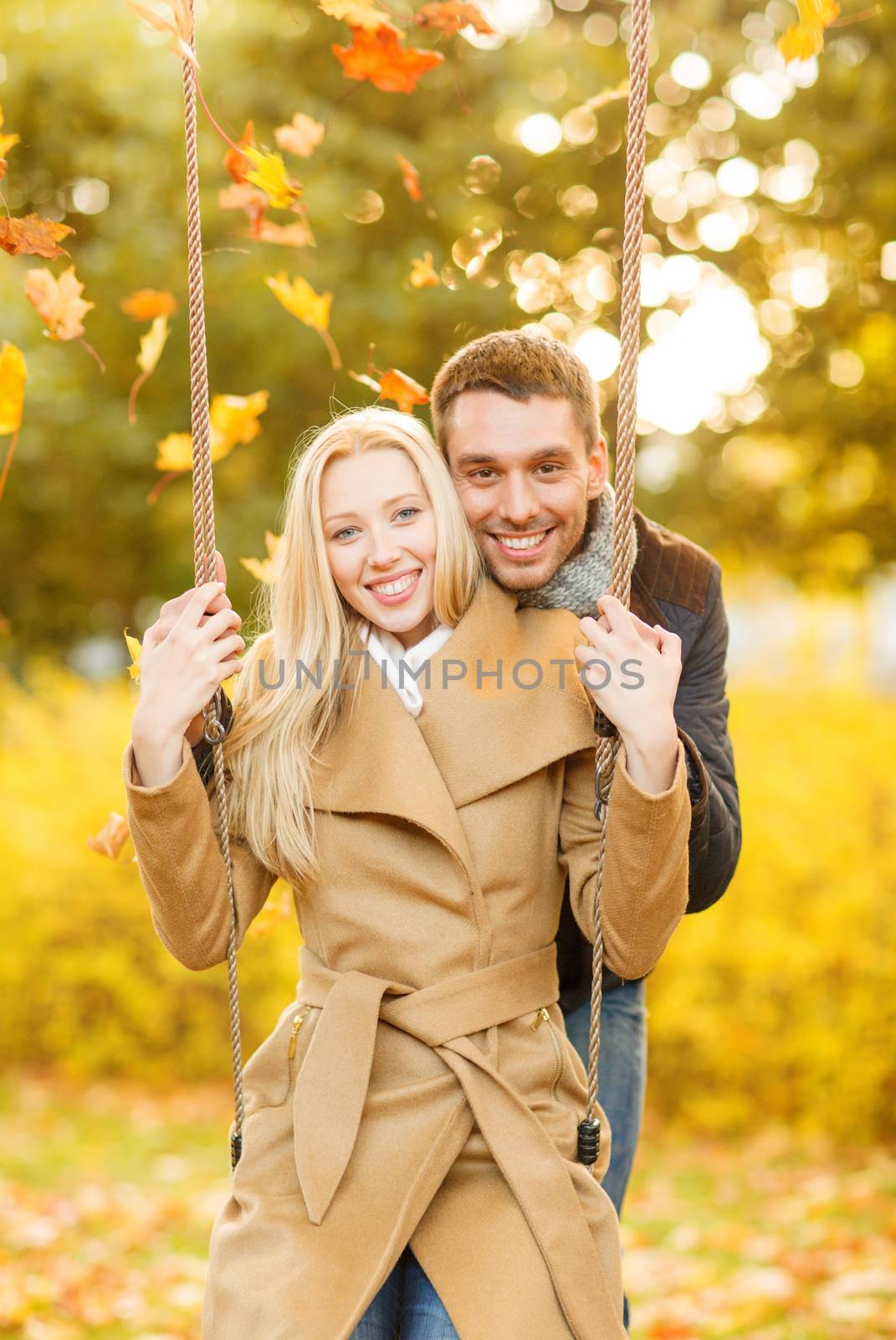 holidays, love, travel, tourism, relationship and dating concept - romantic couple in the autumn park