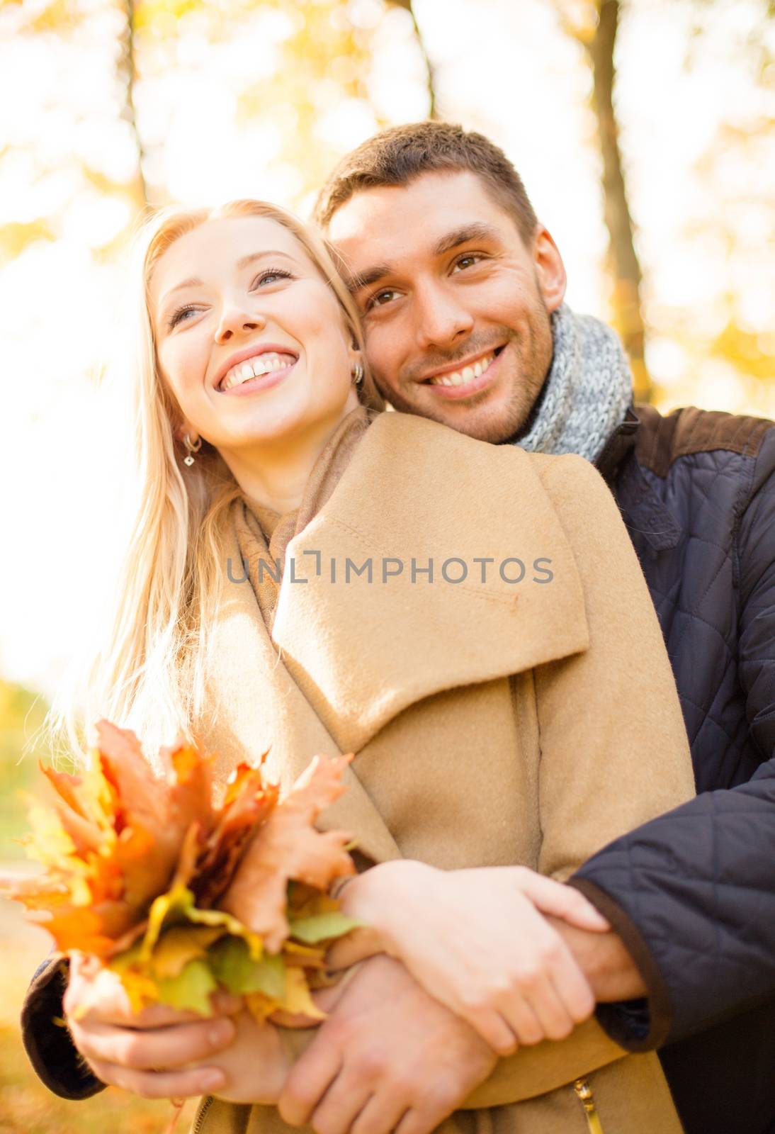 holidays, love, travel, tourism, relationship and dating concept - romantic couple in the autumn park