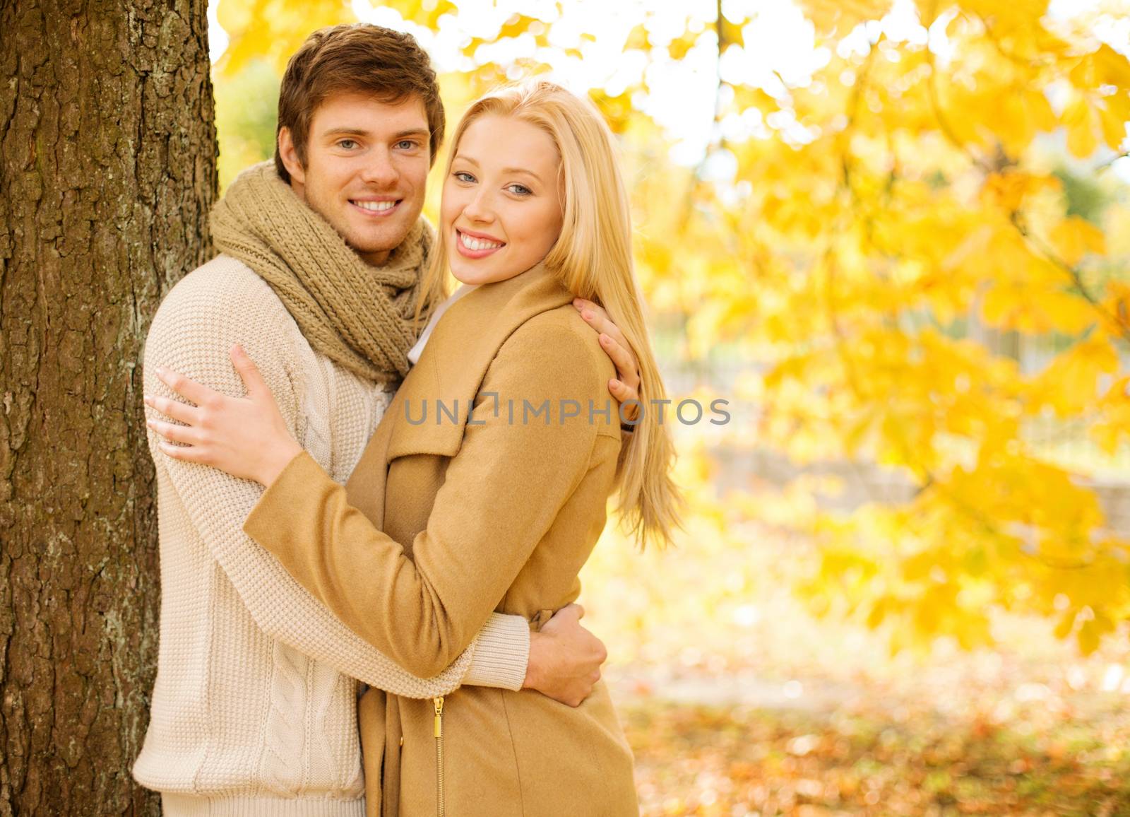 holidays, love, travel, tourism, relationship and dating concept - romantic couple in the autumn park