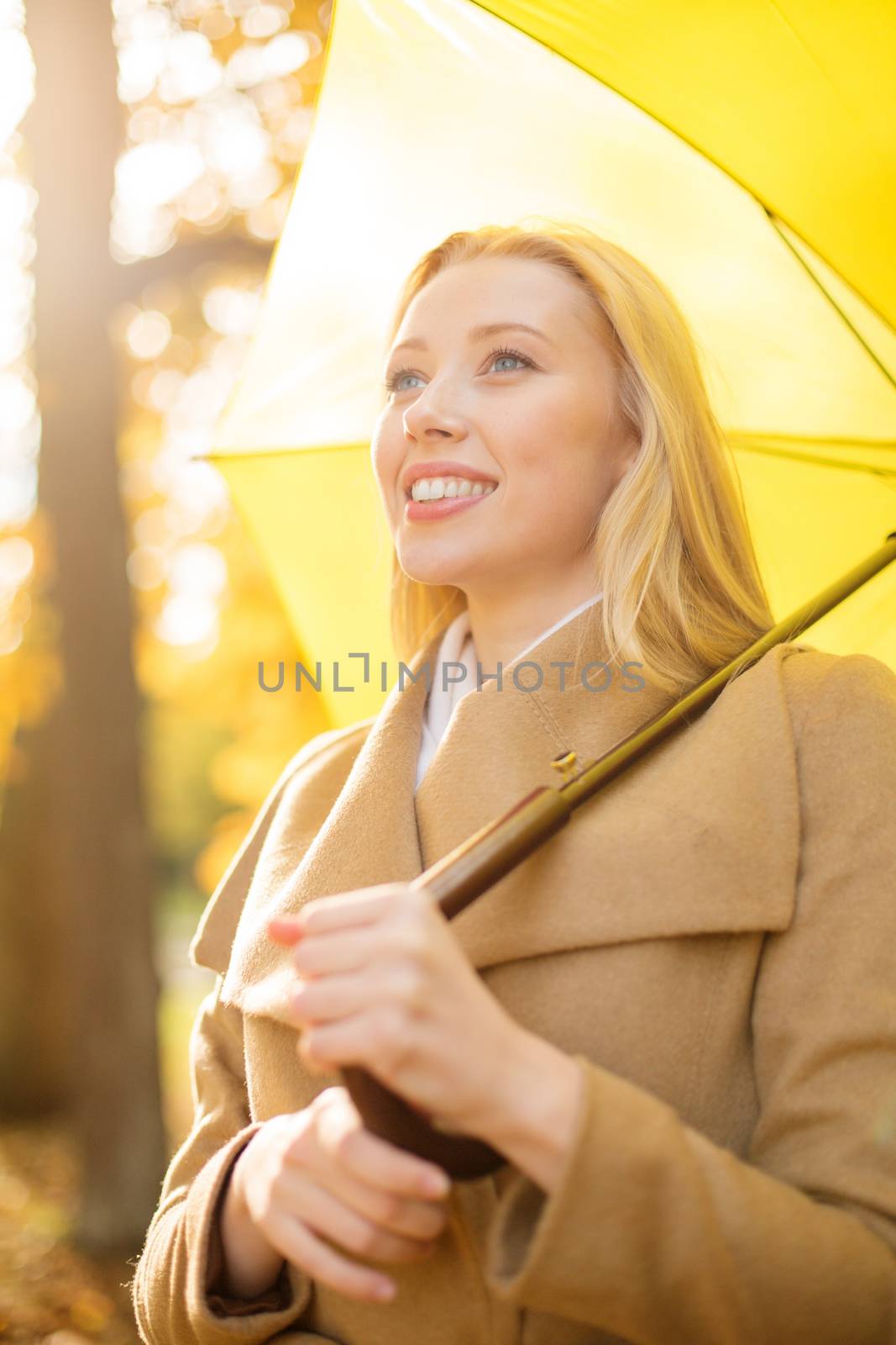woman with yellow umbrella in the autumn park by dolgachov