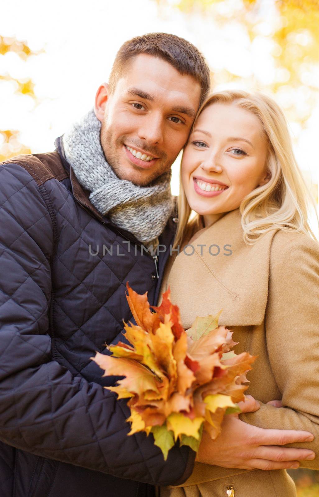 holidays, love, travel, tourism, relationship and dating concept - romantic couple in the autumn park