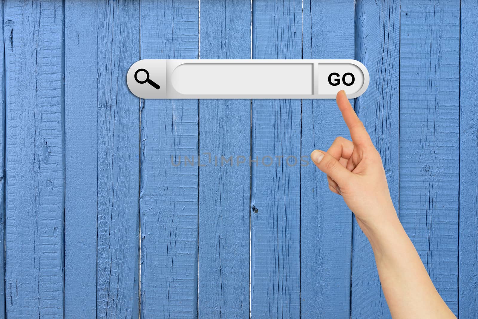 Human hand indicates the search bar in browser. Aged wooden painted surface on background