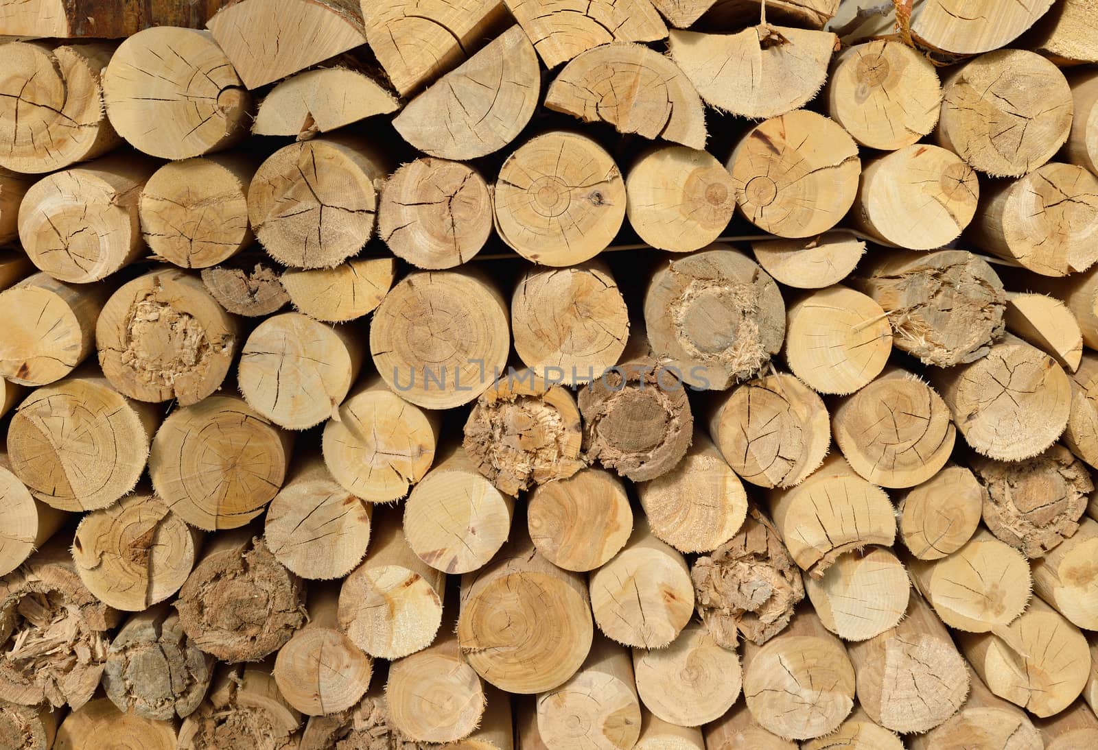 Wood chopped firewood stacked on the stack. Natural background