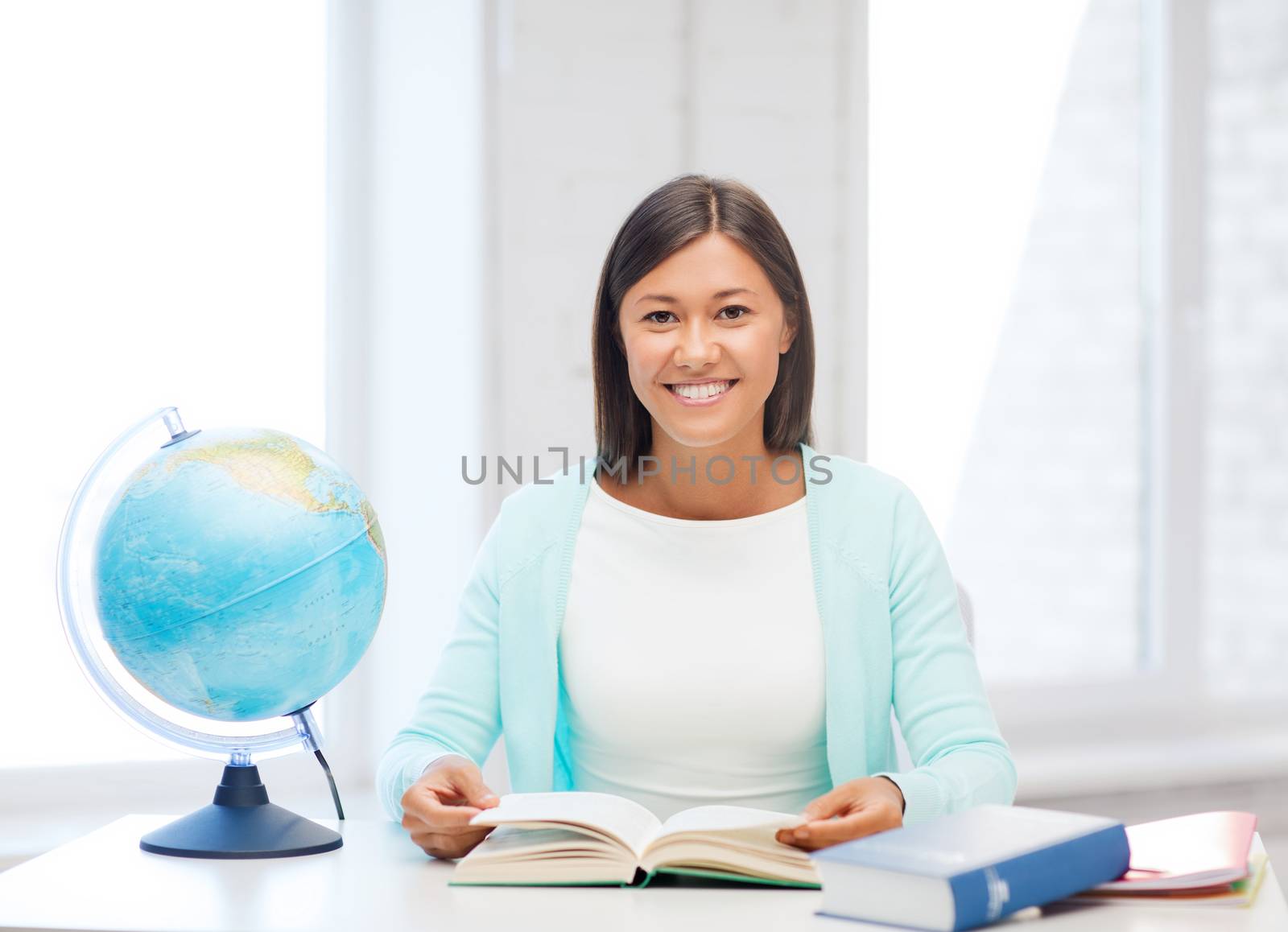 teacher with globe and book at school by dolgachov