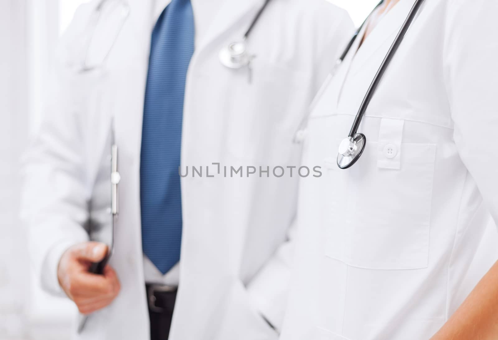 two doctors with stethoscopes by dolgachov