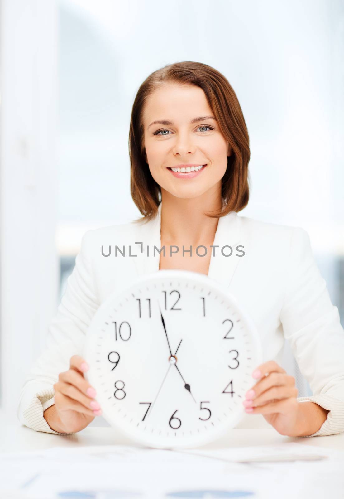 business, office, school and education concept - attractive businesswoman showing clock