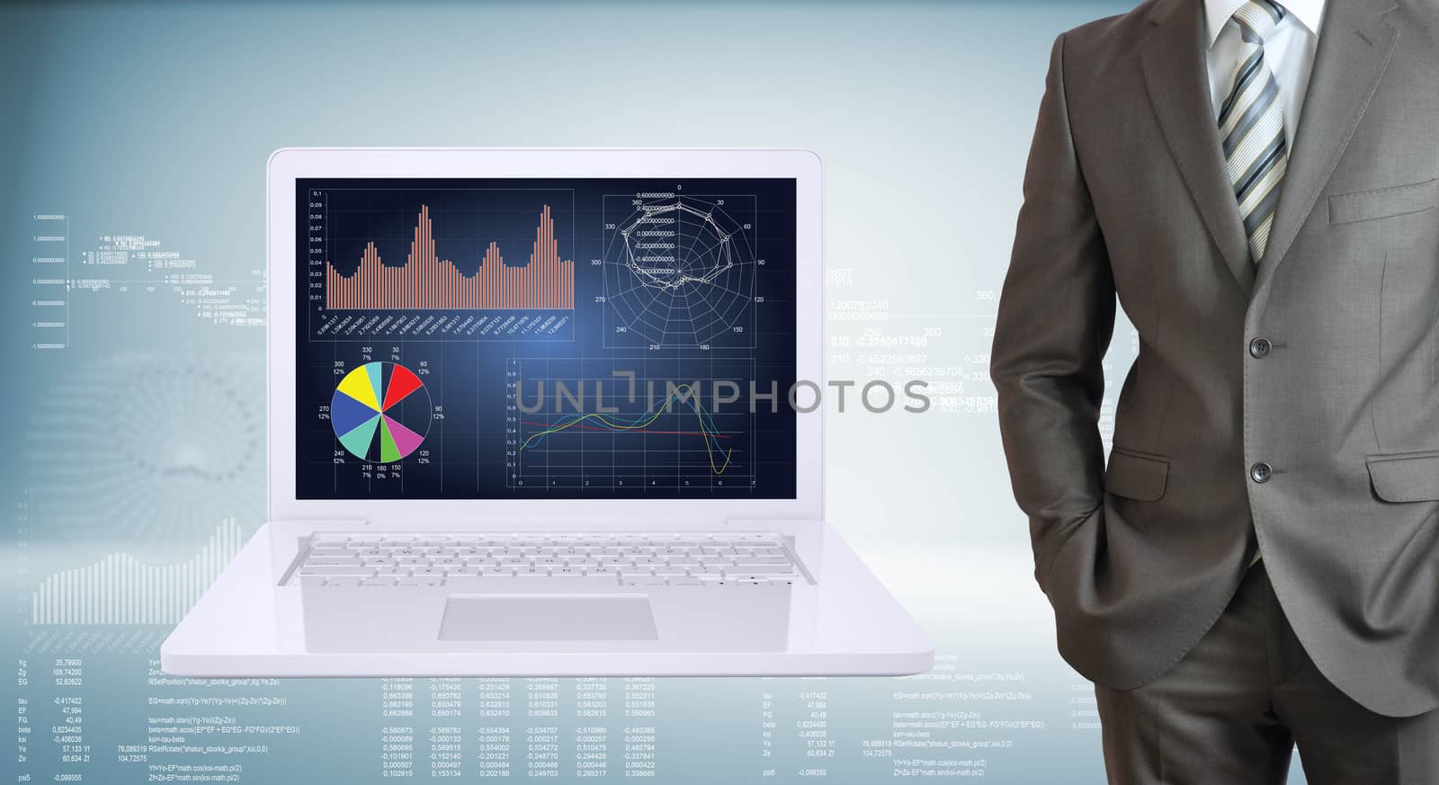 Businessman with open laptop. High-tech graphs at backdrop