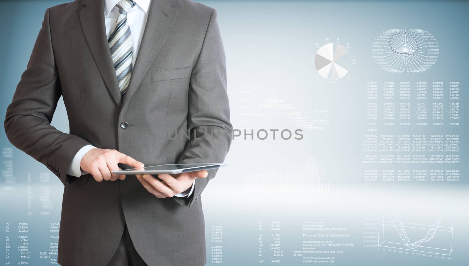 Businessman holding tablet pc. On background of the high-tech graphs