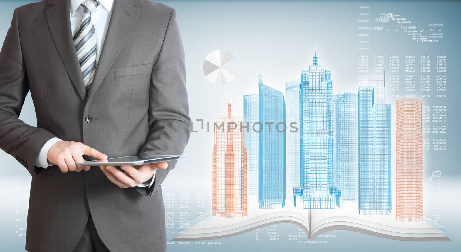 Businessman holding tablet pc. On background of the high-tech wire frame skyscrapers and graphs