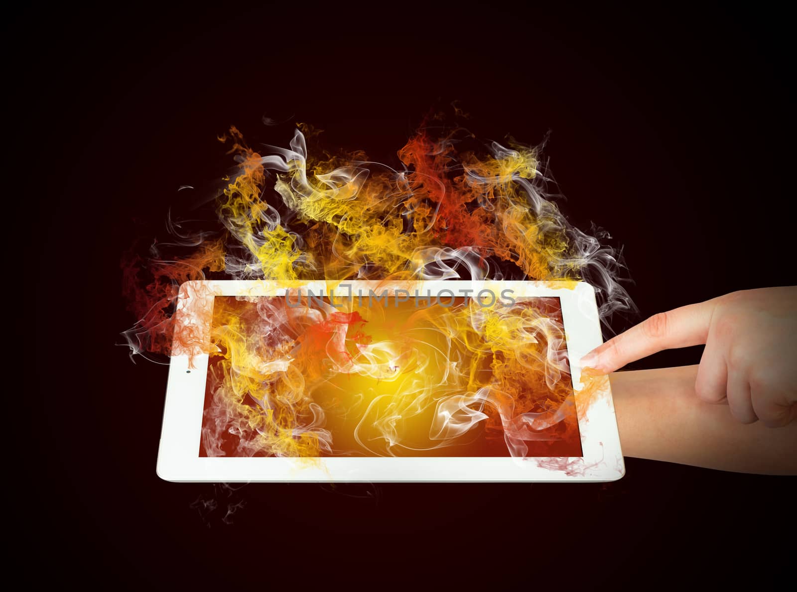 Hands holding tablet pc with colored smoke. The technology concept