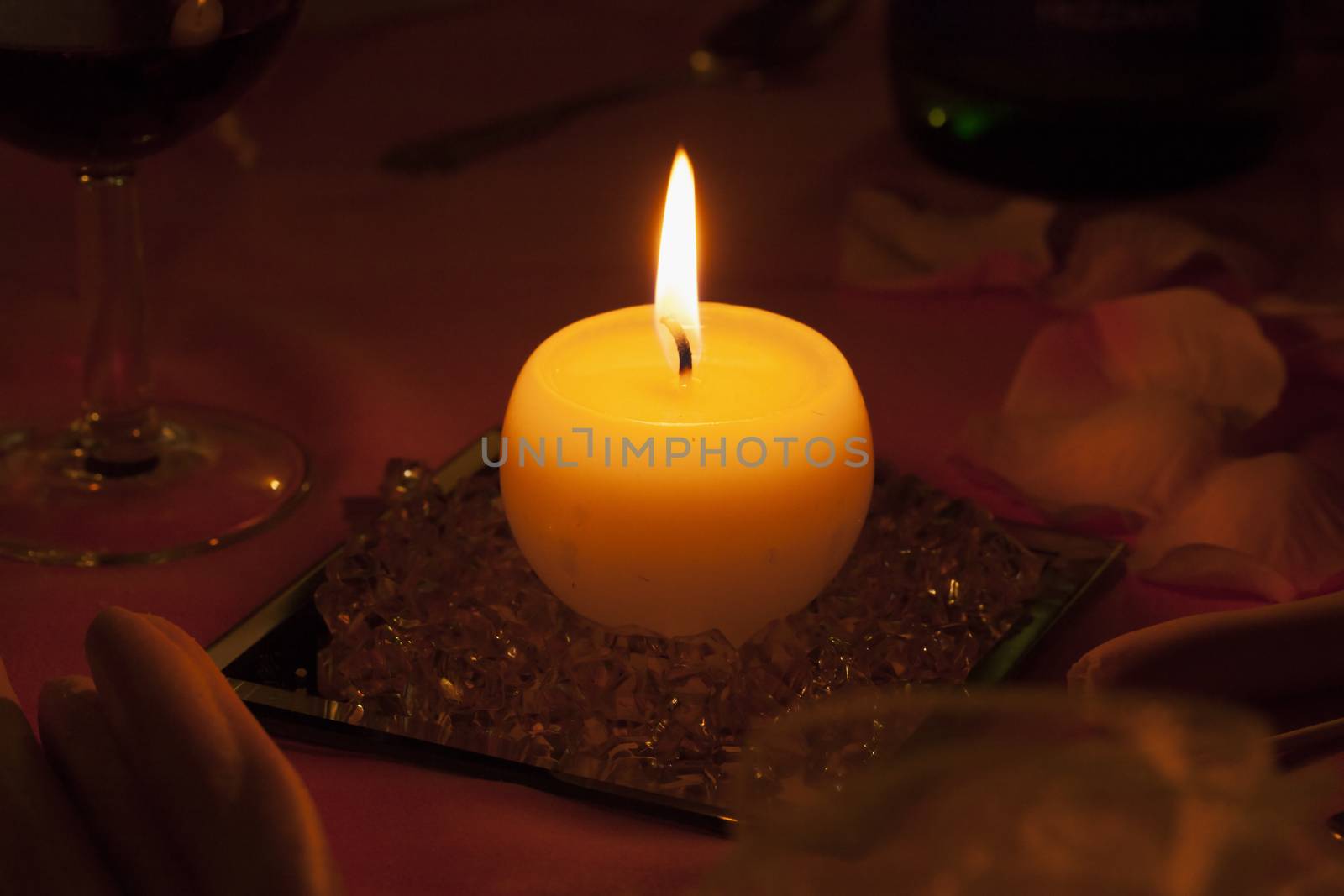 Lit candle in the middle of a lunch table