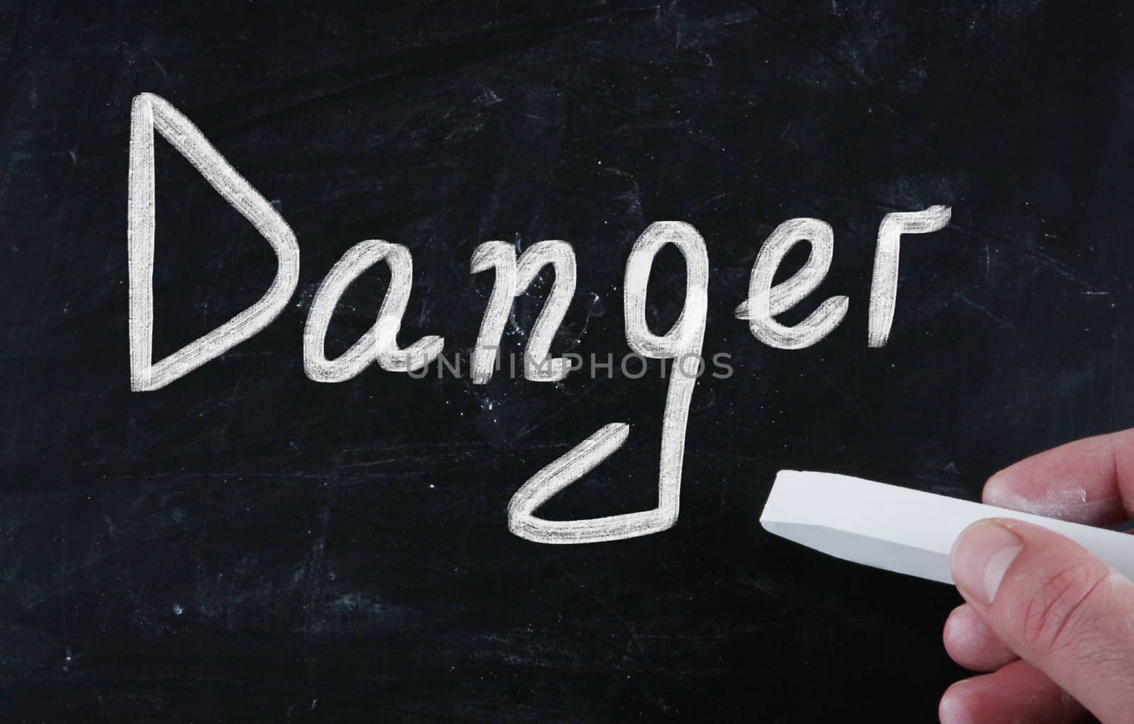 danger handwritten with chalk on a blackboard