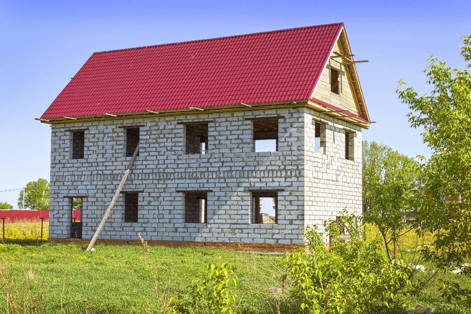 House from foam concrete blocks in the meadow . Completion of construction